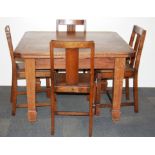 An oak draw leaf dining table and four chairs.