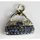 An 18ct white gold sapphire and diamond set handbag shaped pendant, L. 1.5cm.