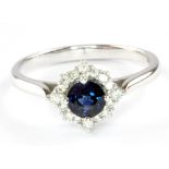 A 9ct white gold sapphire and diamond set cluster ring, (P).