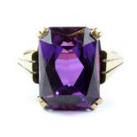 A 9ct yellow gold purple stone set ring, (J.5).