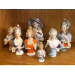 A group of seven porcelain half dolls, tallest H. 12cm.
