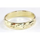 A 9ct yellow gold patterned wedding ring, (O).