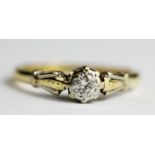 An 18ct yellow and white gold diamond set solitaire ring, (K).