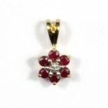 A 9ct yellow gold ruby and diamond set pendant, L. 1.2cm.