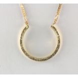 A boxed yellow metal (tested 18ct gold) diamond set pendant on a 9ct gold chain.