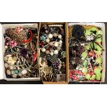 Three boxes of costume jewellery.