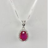 A 925 silver ruby and white stone set pendant and chain, L. 2cm.