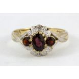 A 9ct yellow gold garnet and diamond set ring, (O).