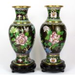 A pair of Chinese 20th Century cloisonne vases on carved wooden stands, overall H. 30cm.