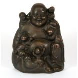 An early 20th Century Chinese cast bronze figure of the happy Buddha with children, H. 14.5cm.