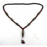 A strand of Tibetan Dzi bead cornelian and black onyx prayer beads, L. 48cm.