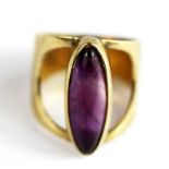 A 9ct yellow gold oval cabochon cut amethyst set ring, (M).