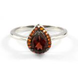 A 925 silver garnet and orange sapphire set cluster ring, (P.5).