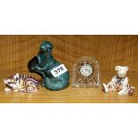 Two small crown Derby paperweights, a Waterford crystal clock and a Poole pottery seal.