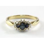 A 9ct yellow gold sapphire and diamond set cluster ring, (Q).