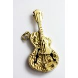 A 9ct yellow gold guitar shaped pendant, L. 3.8cm.