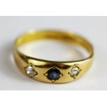 A gentleman's yellow metal (tested 18ct gold) sapphire and diamond set gypsy ring, (P).