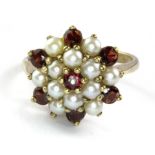 A 9ct yellow gold garnet and pearl set large cluster ring, (Q).