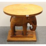 A carved teak elephant table, H. 55cm.