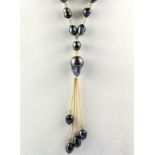 A large yellow metal and black cultured pearl necklace, L. 55cm.