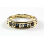 A 9ct yellow gold sapphire and diamond set half eternity ring, (N.5).