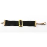 A Victoriab 9ct yellow gold and black silk mourning bracelet.