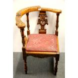 An ornately carved 19th century corner chair, H. 84cm.