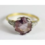 An 18ct yellow gold and platinum octagonal cut amethyst set ring, (T.5).