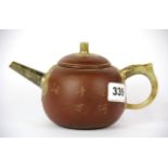 A Chinese Yixing terracotta teapot with jade spout and handle, spout to handle L. 18cm H. 10cm.