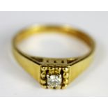 An 18ct yellow gold diamond set solitaire ring, (K.5).