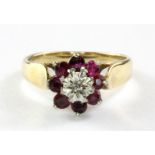 A 9ct yellow gold ruby and diamond set cluster ring, (L.5).