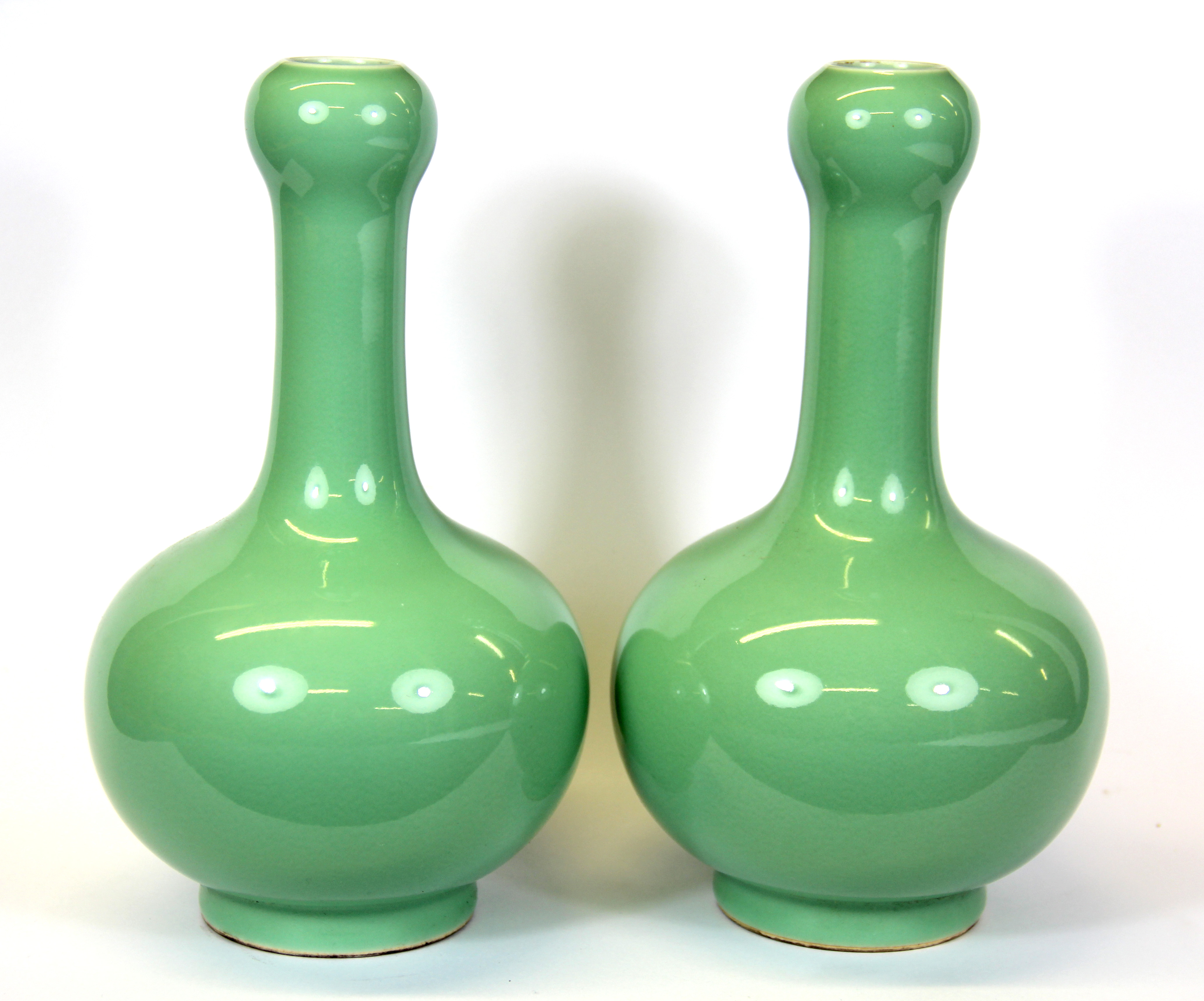 A pair of Chinese celadon glazed porcelain vases, H. 22cm.