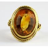 An 18ct yellow gold ring set with an oval step cut citrine, (L).