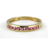 A 9ct yellow gold tourmaline set half eternity ring, (P.5).