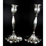 A pair of hallmarked silver candlesticks, H. 30cm Weight. approximately 730g. One A/F.