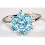 A 925 silver blue topaz set cluster ring, (R).