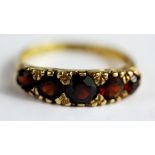 A 9ct yellow gold garnet set ring, (N.5).