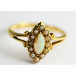 An 18ct yellow gold (marked 18) opal and seed pearl set cluster ring, (opal a/f).