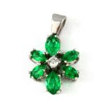 A white metal (tested 9ct gold) tsavorite and diamond set flower shaped pendant, L. 2cm.