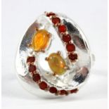 A Hana Maae designer 925 silver ring set with cabochon cut opals and carnelian, (K).