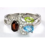 A 925 silver peridot, blue topaz and garnet set ring, (Q).