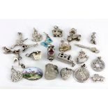 A quantity of silver charms / pendants.