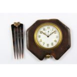 A vintage travel clock, Dia. 6cms with a rose metal mounted tortoiseshell hair comb.