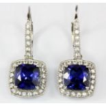 A pair of 14ct white gold (stamped 14k) drop earrings set with synthetic sapphires and white