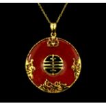 A gilt metal hardstone set pendant and chain, L. 5cm.