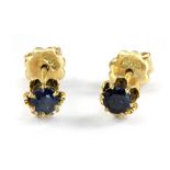 A pair of 14ct yellow gold (stamped 585) sapphire set stud earrings.