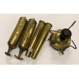 Two vintage brass fire extinguishers, two World War Two brass shells and brass gas stove.