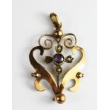 An Edwardian 9ct yellow gold amethyst and seed pearl set pendant, (one pearl missing), L. 3.5cm.