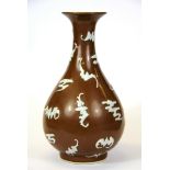 A Chinese brown glazed porcelain vase decorated in relief with white glazed bats, H. 23cm.