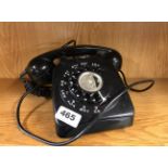 A vintage black telephone.